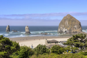 Canon Beach rocks and surf Oregon coast 10 Reasons to Visit the Northern Oregon Coast will give you some amazing ideas for vacation locations to visit. Looking for the perfect beach getaway? The Oregon beach towns of Tillamook, Garibaldi, Rockaway, Wheeler, Seaside, Cannon Beach and Astoria are filled with fun family activities. Many of them are free. Learn about things to do on the northern coast of Oregon and plan your northern Oregon coast roadtrip using this as your guide! #northernoregoncoasttravel #familytraveltips #beachtrip