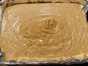 Easy Peanut Butter Fudge with Marshmallow Creme poured into pan