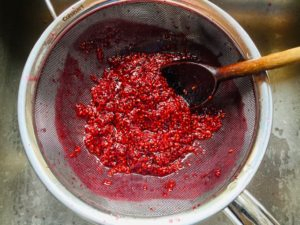 canned raspberry syrup recipe in sieve