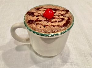 How to make easy cake in a mug recipe with a chocolate mug cake with a cherry on top