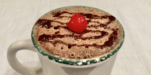 Super simple mug cake featured image chocolate mug cake with cherry on top