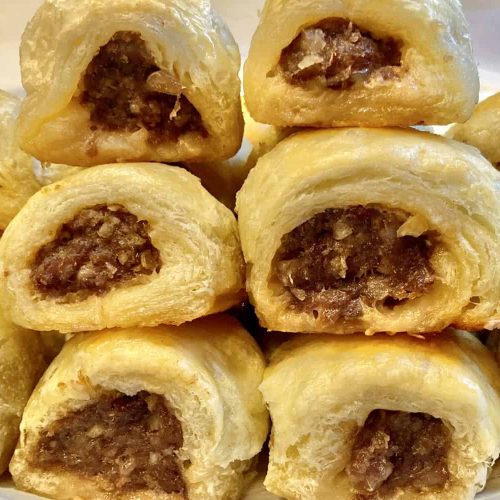 mini sausage rolls stacked on a plate