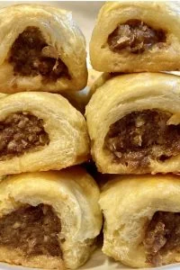 mini sausage rolls with puff pastry stacked closeup