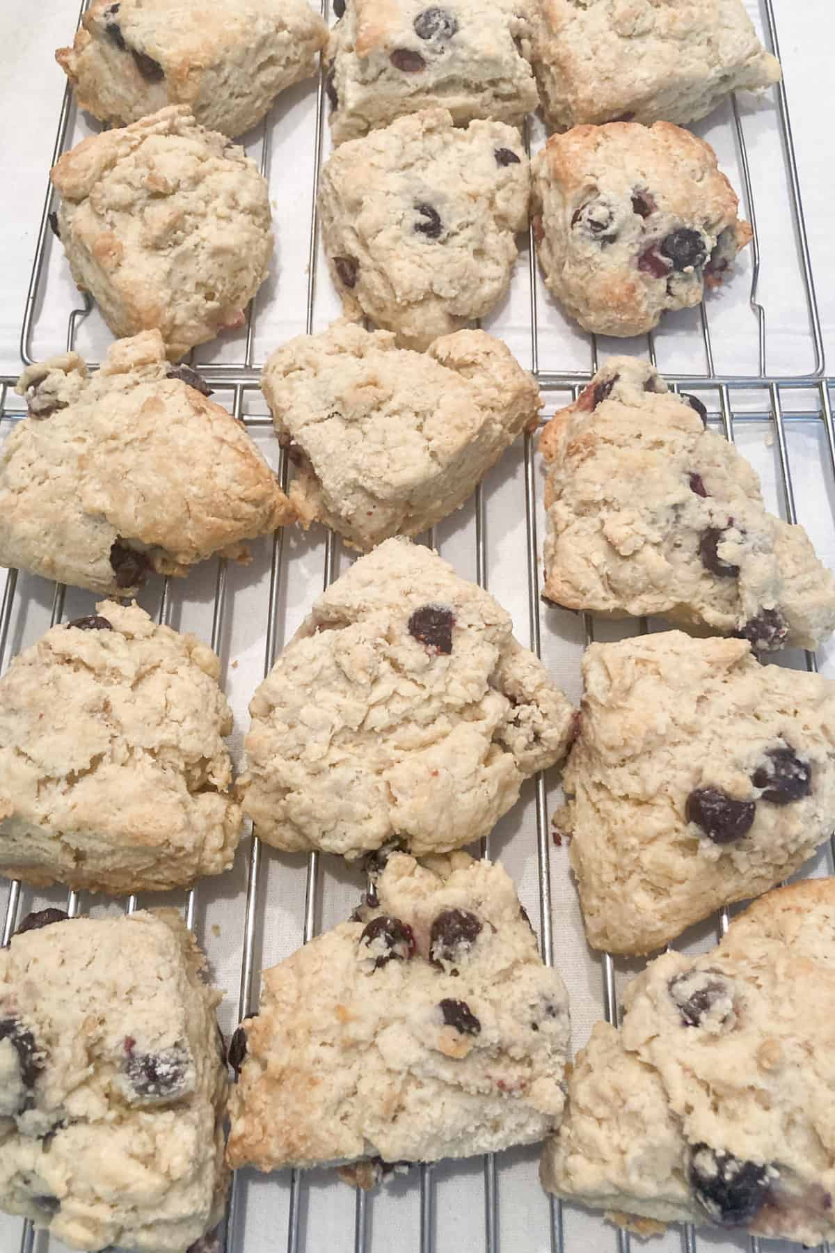 glazed lemon blueberry scones without heavy cream cooling on a wire rack
