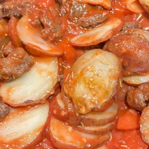 potatoes with tomatoes, sausage, rosemary and garlic ready to eat