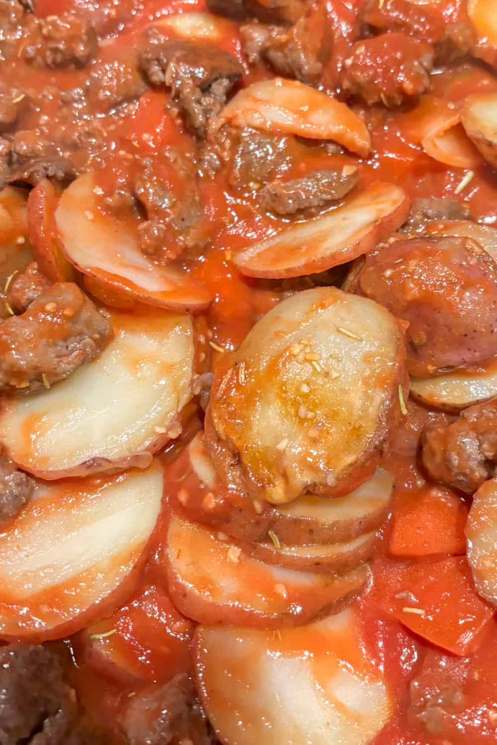 potatoes with tomatoes, sausage, rosemary and garlic ready to eat 