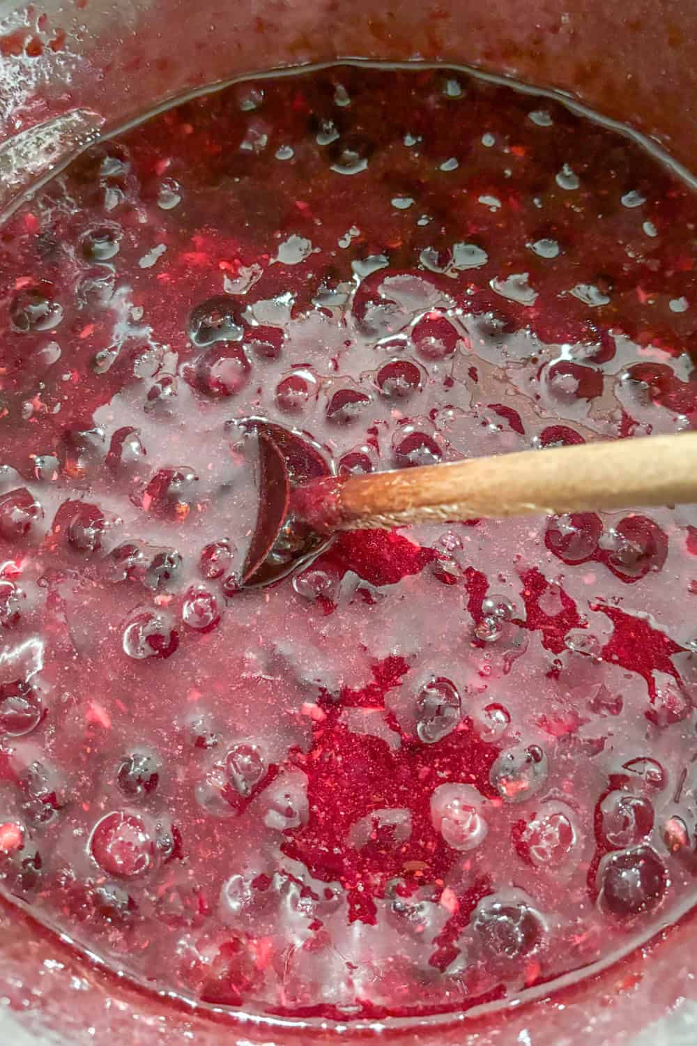 stirring blueberry orange jam