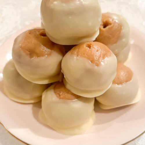 white chocolate buckeyes and white chocolate peanut butter truffles on a plate