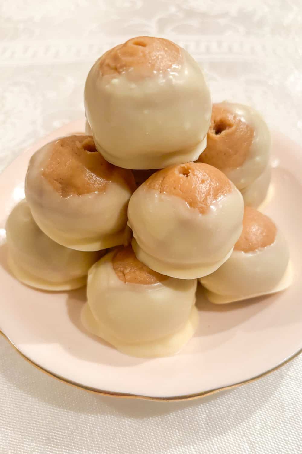 white chocolate buckeyes and white chocolate peanut butter truffles on a plate