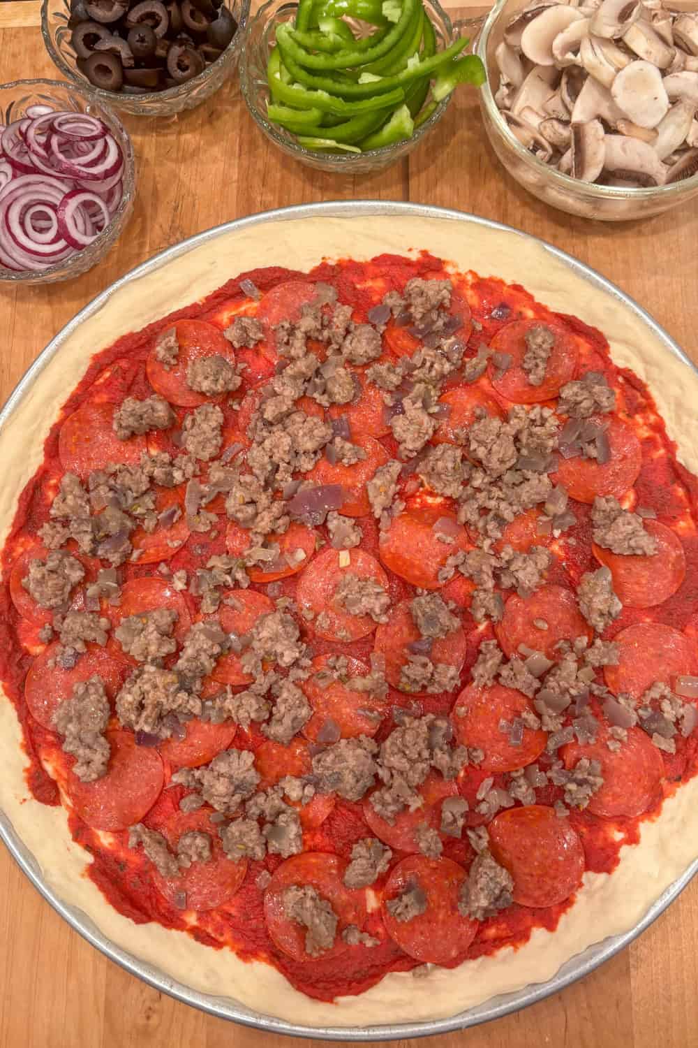 best bread machine pizza dough being topped