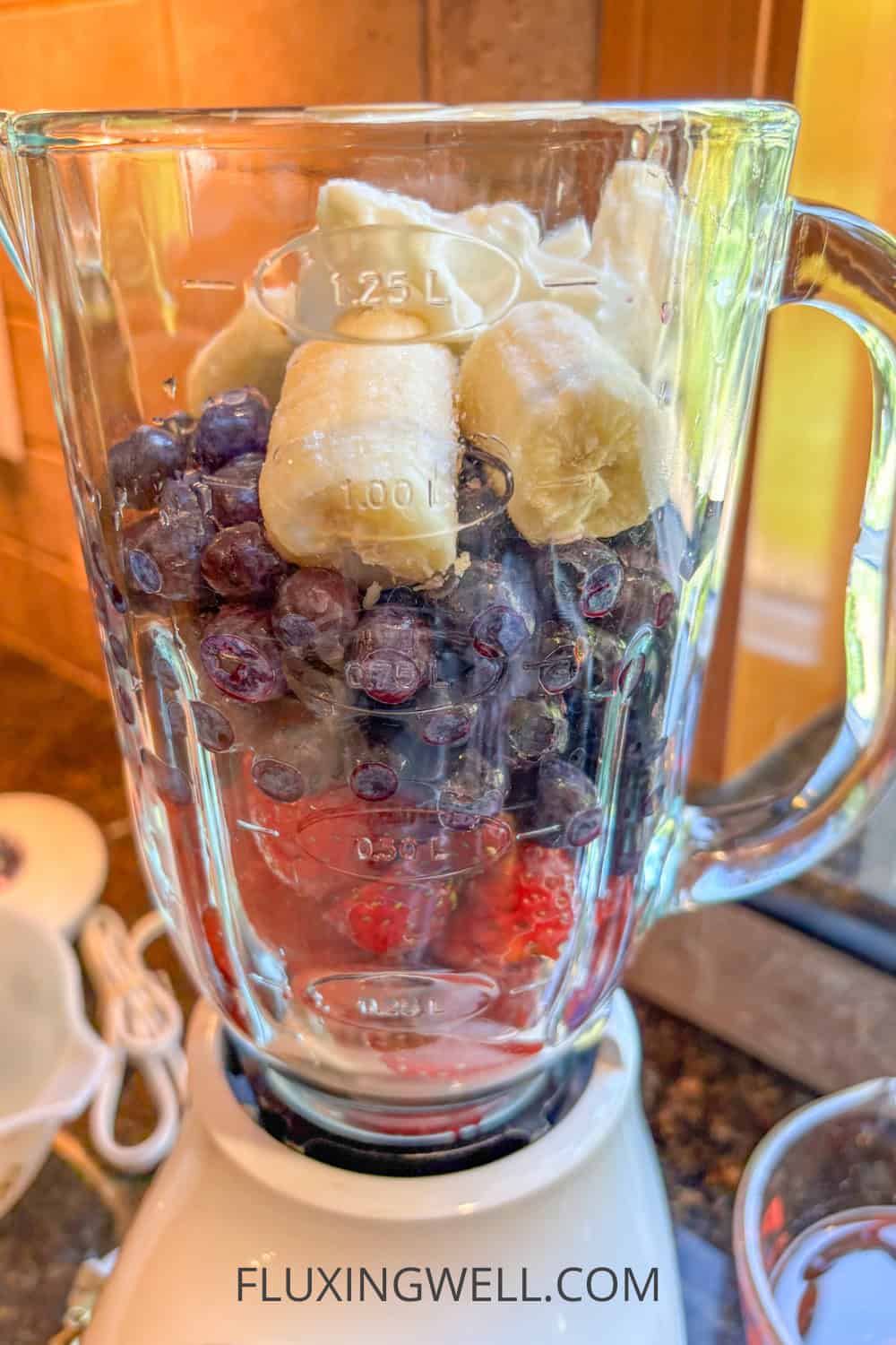 strawberry banana and blueberry smoothie in blender