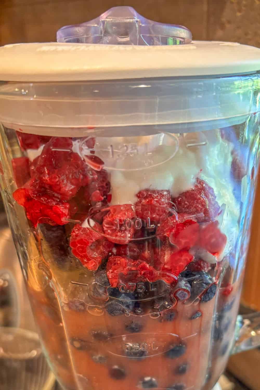 raspberry blueberry smoothie ingredients in a blender