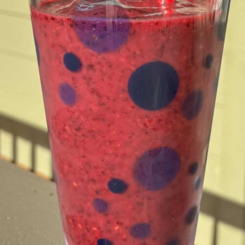 raspberry blueberry smoothie in a cup on a sunny day