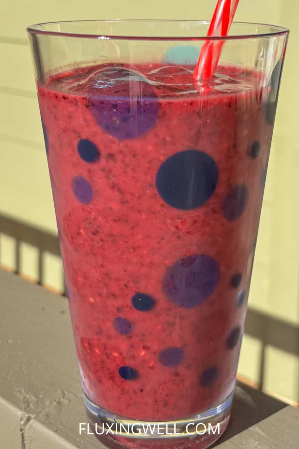 raspberry blueberry smoothie in a cup on a sunny day